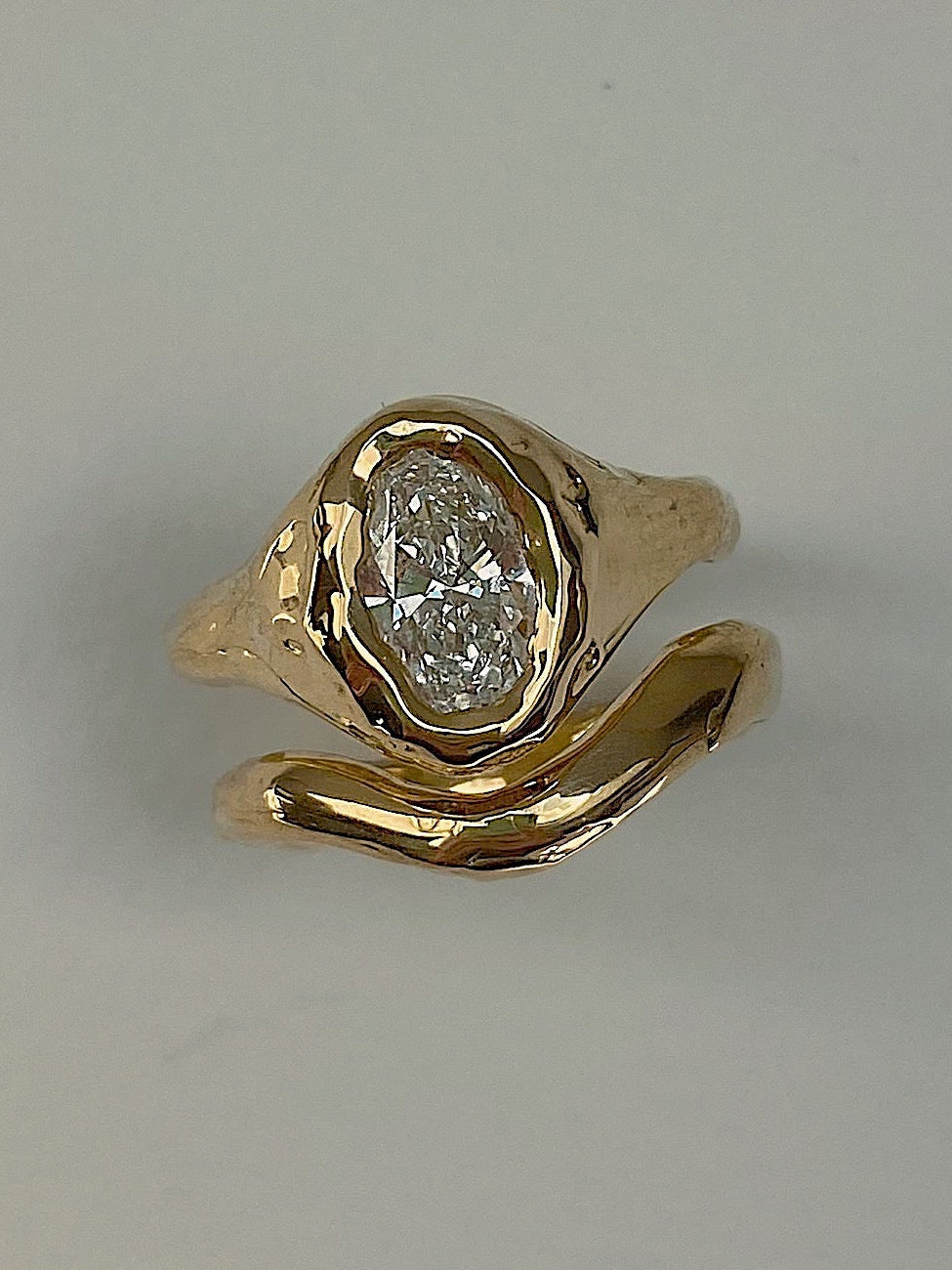 Ring set for brides. 18 karat gold engagement and wedding ring set with 1 carat oval diamond in organic chunky setting