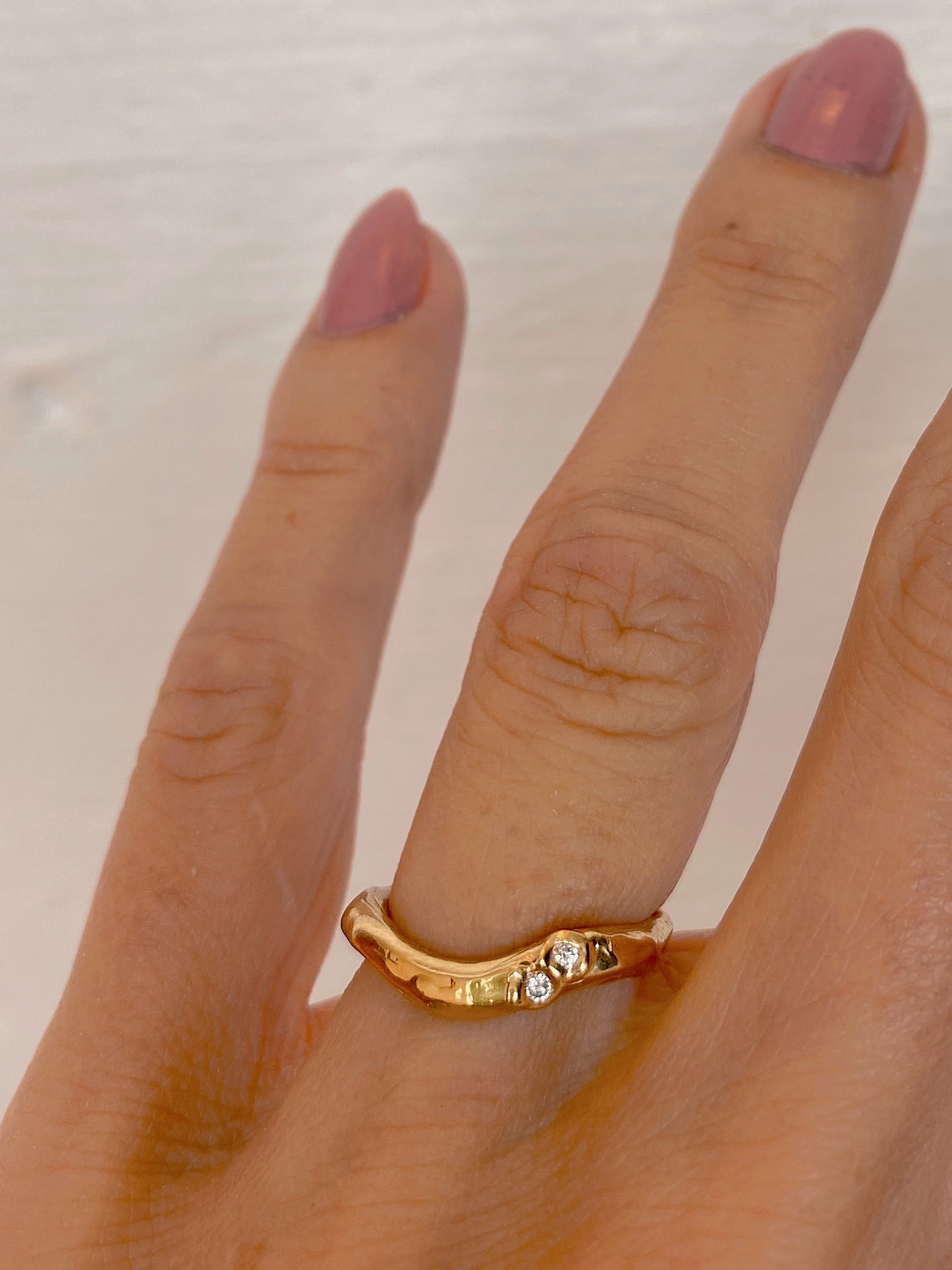 Organic cute wavy wedding ring with diamonds in organic setting
