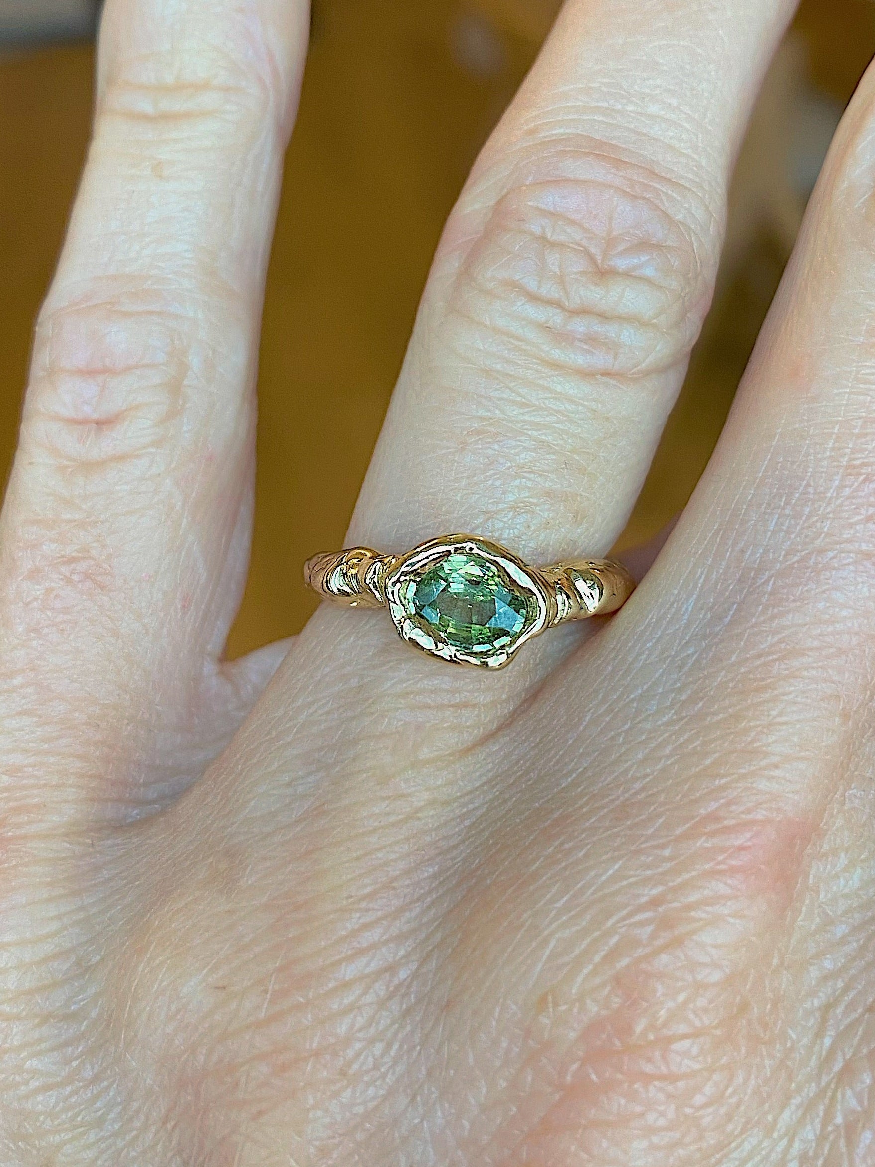 Organic chunky east west engagement ring with oval green sapphire